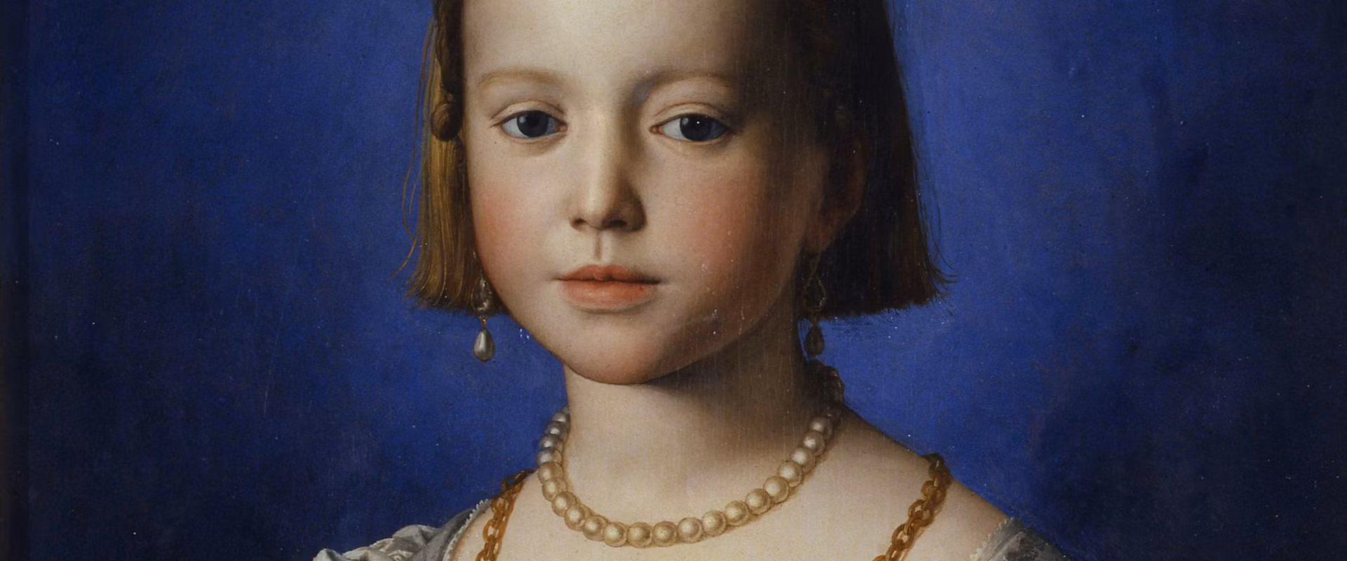 A young girl with blonde hair, wearing a pearl necklace and earrings, is depicted against a deep blue background, showcasing a serene expression.