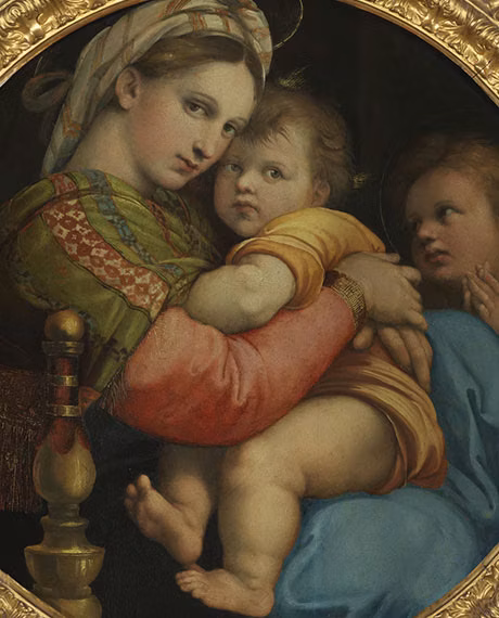 A Renaissance painting depicts a woman in a patterned headscarf holding a child with cherubic features and rosy cheeks, while another child looks on, set against a dark, muted background and framed by an ornate, golden border.