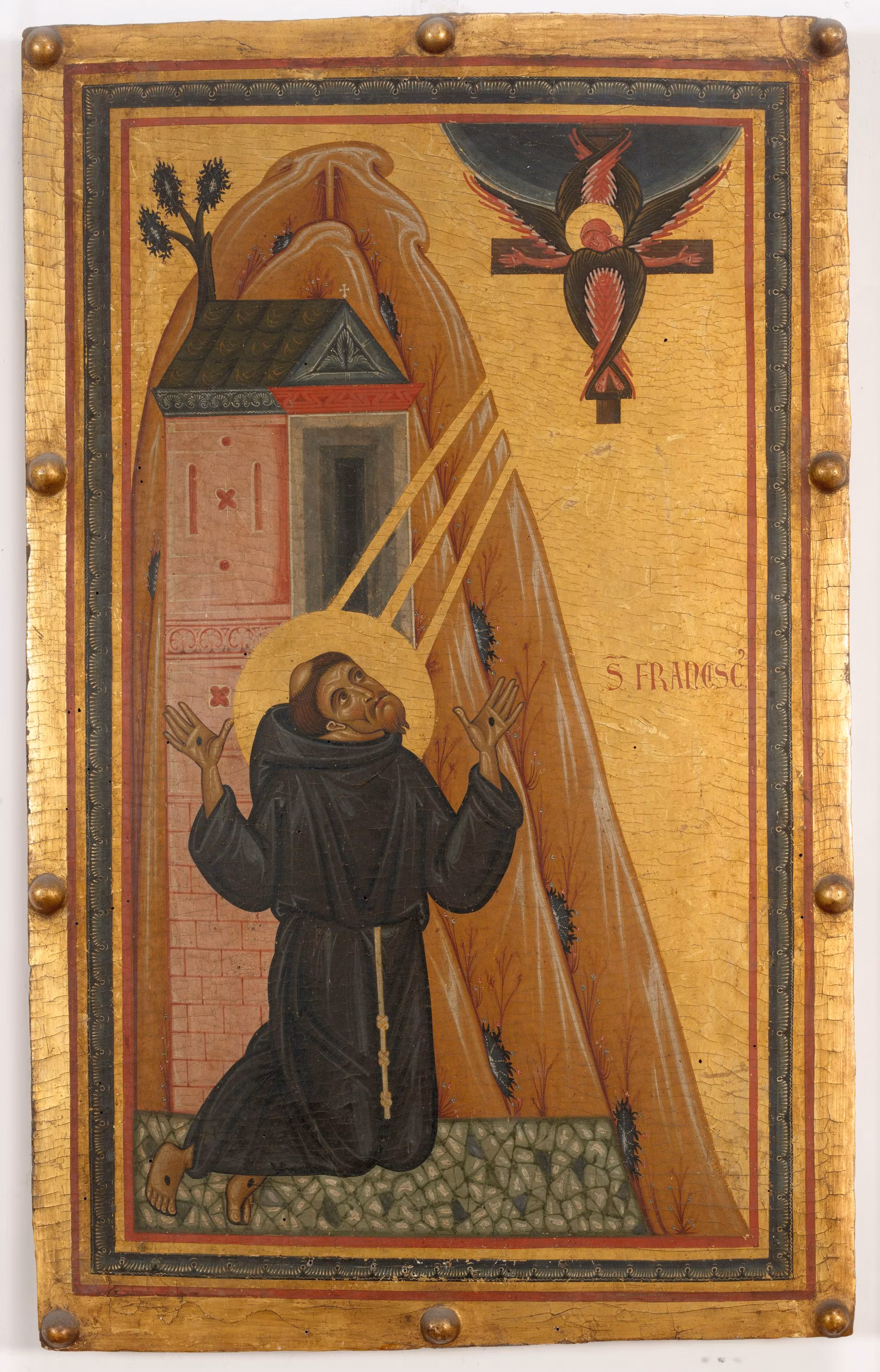 L'immagine raffigura un dipinto religioso che mostra un monaco inginocchiato sotto un raggio di luce dorata, che emana da un crocifisso sospeso nel cielo, con una chiesa e una montagna sullo sfondo.