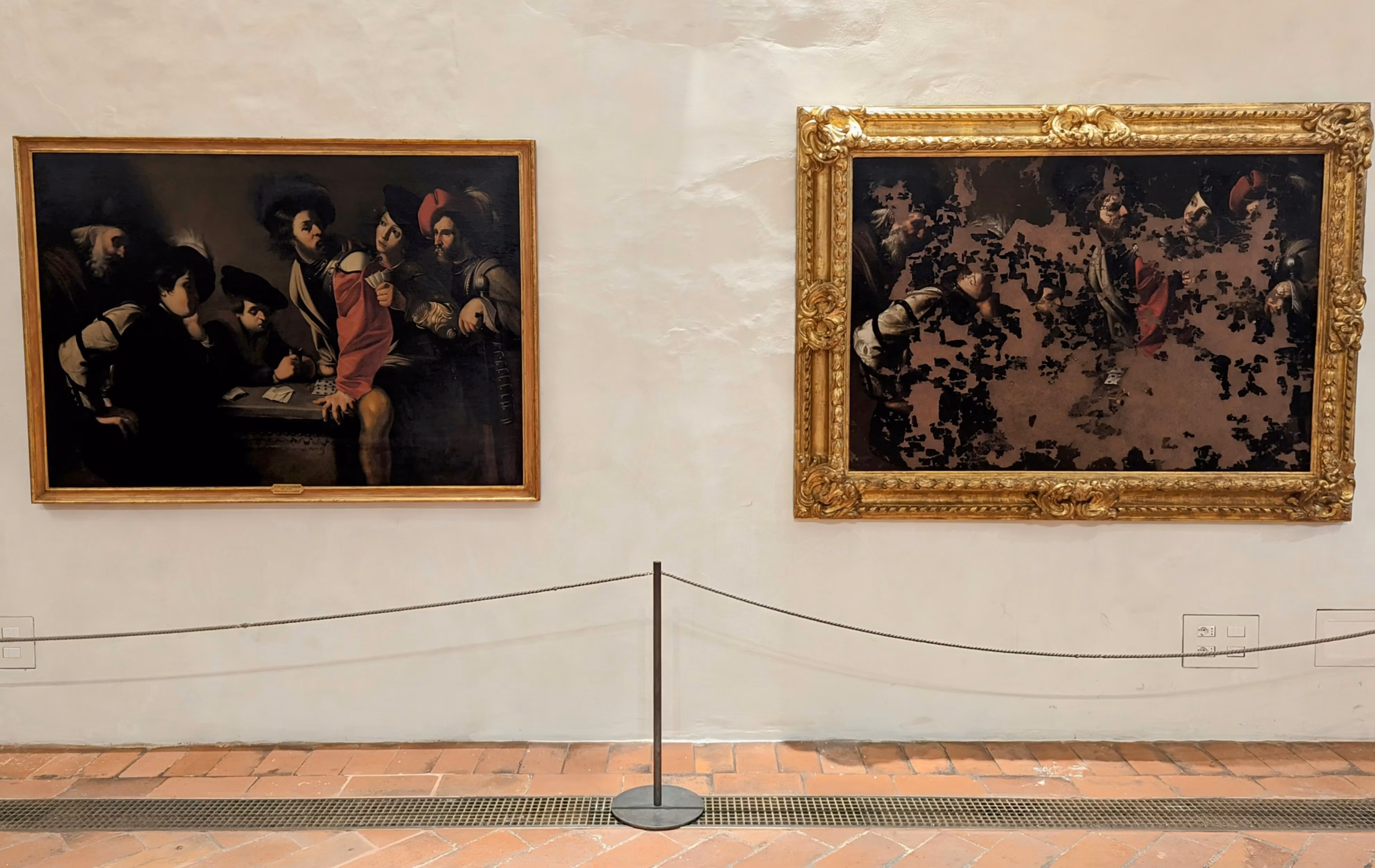 Two framed paintings are mounted on a white wall, with one more traditionally styled and the other appearing fragmented or distorted, separated by a barrier on a brick floor, creating a contrast between classic art and modern interpretation.