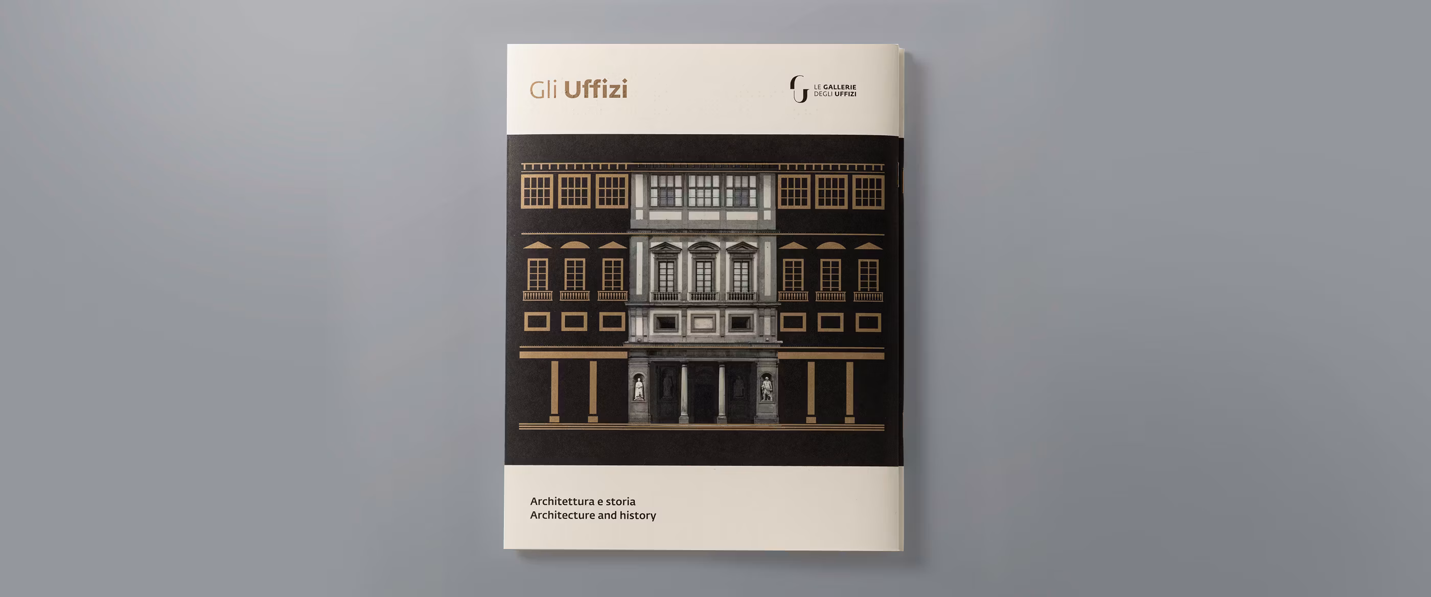 The image shows the front cover of a publication titled "Gli Uffizi," featuring an architectural illustration of a classical building with symmetrical columns and ornate windows, set against a neutral gray background; it promotes "Architecture and History."